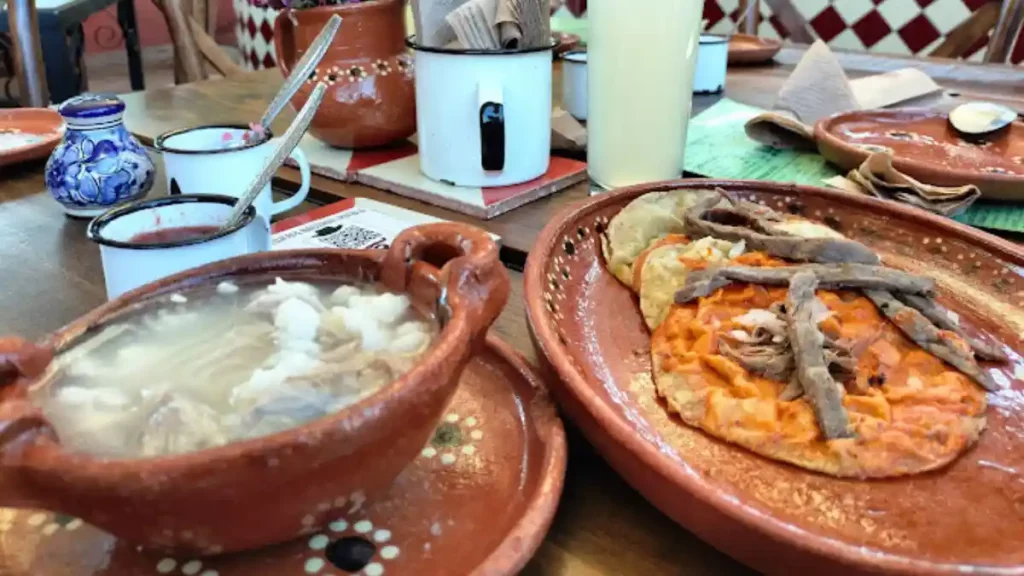 Cazuela de pozole y un plato de chalupas del restaurante Antojería Nacional.